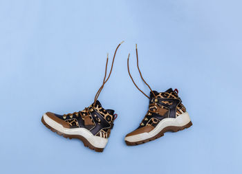 Women shoes brown leopard print on blue background. stylish trendy autumn winter female boots