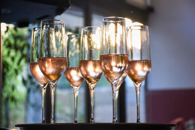 Close-up of wine glasses on table