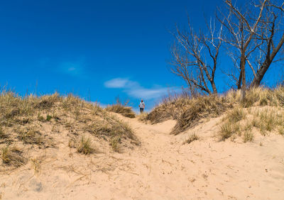 Man standing at beach against sky