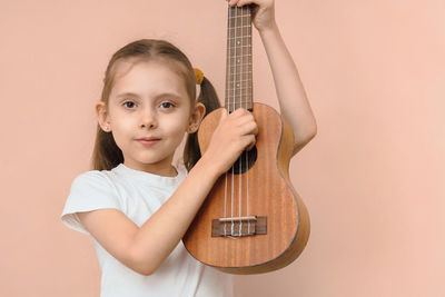 Portrait of boy playing guitar