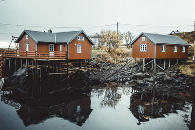 Houses by building against clear sky during winter