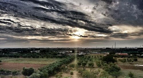 Scenic view of field against sky at sunset