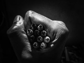 Close-up of human hand against black background