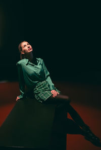 Portrait of cute girl sitting on stage