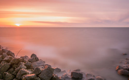 Scenic view of sea against dramatic sky