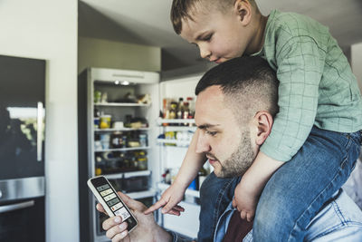 Side view of man using mobile phone