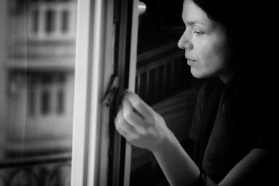 Woman looking through window