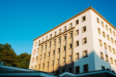 Low angle view of building against clear blue sky