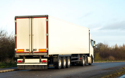 Train on highway against sky