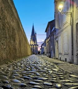 Street amidst buildings against sky in city