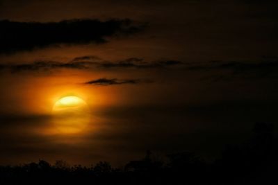 Low angle view of silhouette trees against romantic sky