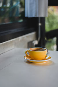 Close-up of coffee cup on table