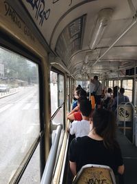 Rear view of people traveling in train