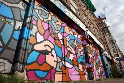 Low angle view of graffiti on wall in city