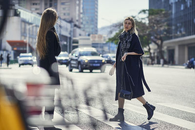 Women walking on street in city