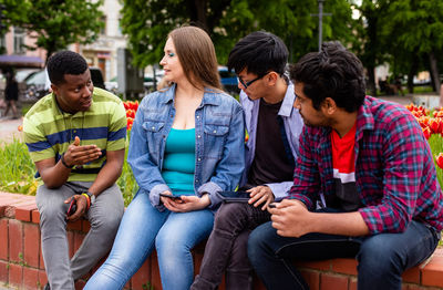 Group of people sitting on mobile phone