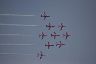 Low angle view of airshow against sky