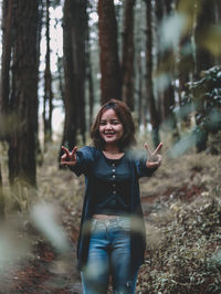 Portrait of a smiling young woman in forest