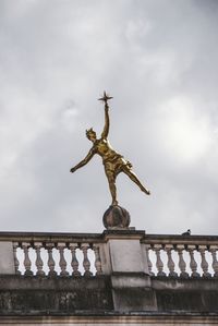 Statue against sky in city
