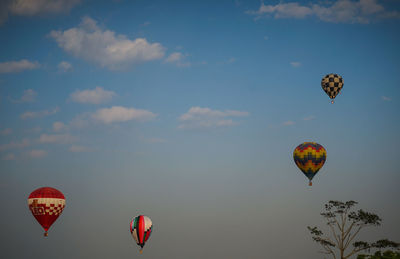 Low angle view of hot air balloons flying in sky