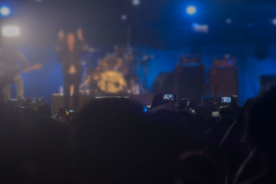 People photographing at music concert