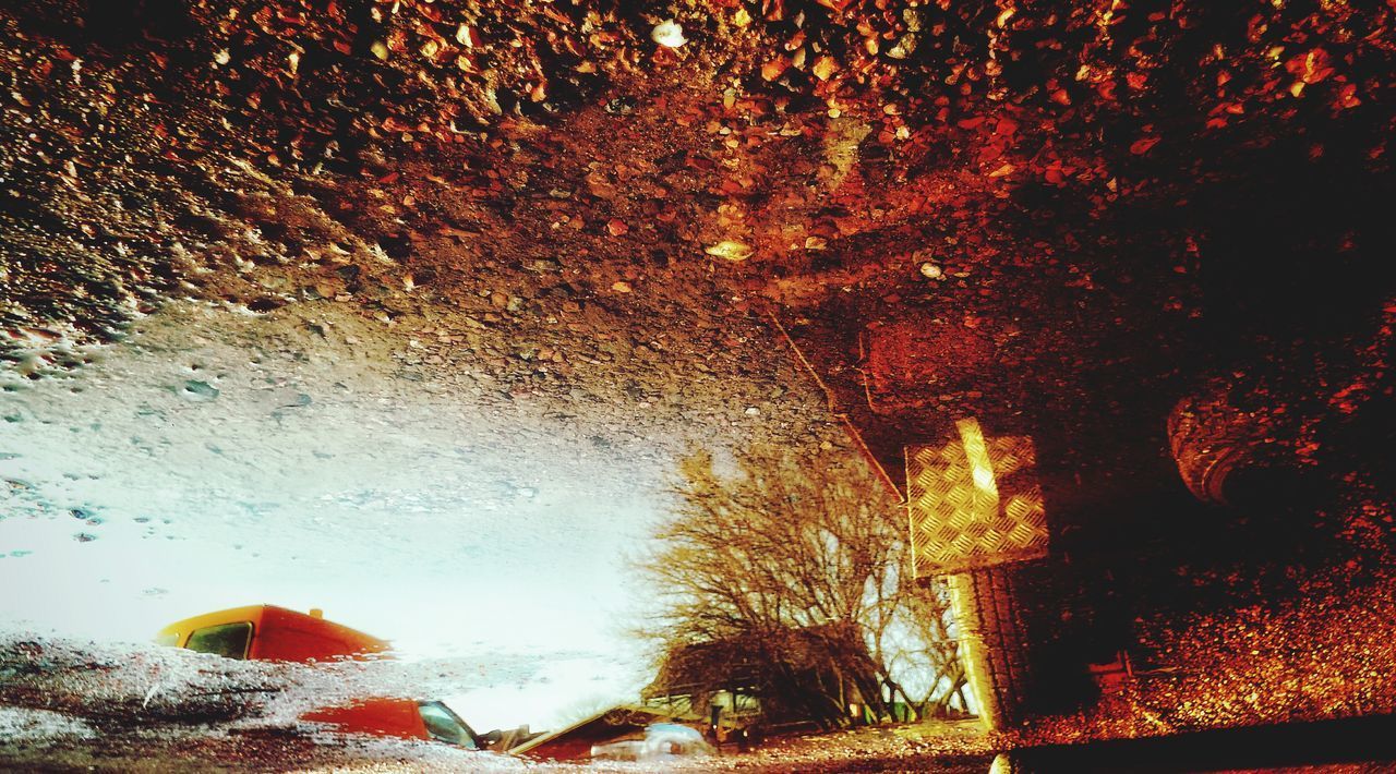 CLOSE-UP OF ILLUMINATED BUILDING WITH WATER