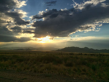 Scenic view of field against sky during sunset