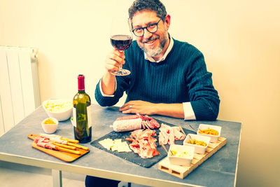 Portrait of senior man using mobile phone at home