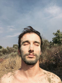 Close-up of young  man against sky