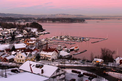 High angle view of cityscape at harbor during sunset