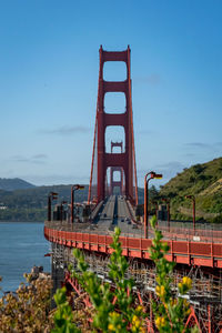 Bridge over sea against clear sky