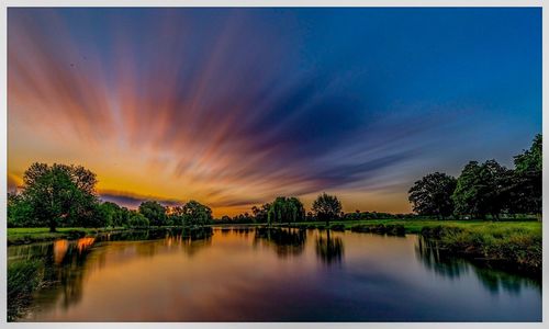 Scenic view of lake against sky during sunset