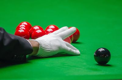 Cropped hand arranging balls on pool table