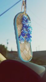 Close-up of umbrella against sky seen through car windshield