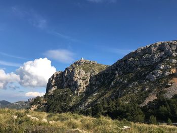 Low angle view of mountain against blue sky