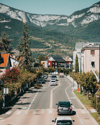 Cars on road by buildings in city