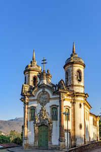 Low angle view of historic building against clear blue sky