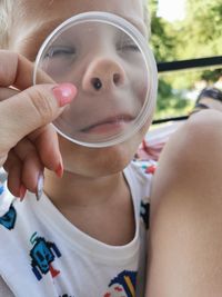 Close-up portrait of a girl holding camera