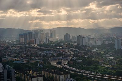 High angle view of city buildings against sky during sunset