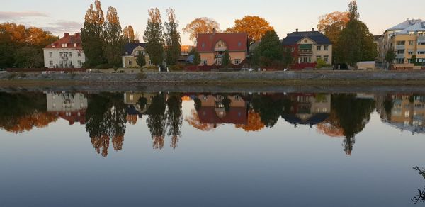 Reflection of buildings on lake against sky