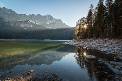 Scenic view of lake and mountains against sky