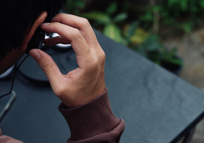 Midsection of man using mobile phone outdoors