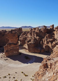 Rock formations against clear blue sky