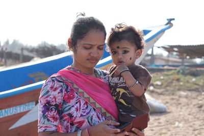 Little one years old boy portraits with mother in summer afternoon on beach chennai, marina beach,