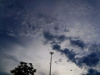 Low angle view of silhouette trees against sky