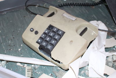 High angle view of damaged landline phone on table