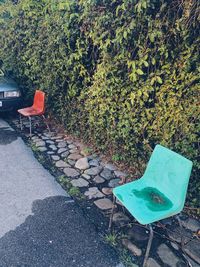 Empty chairs and tables against wall