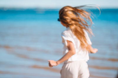 Full length of woman standing at beach