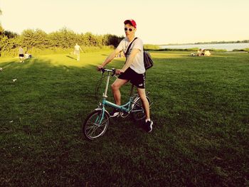 Man riding bicycle on field