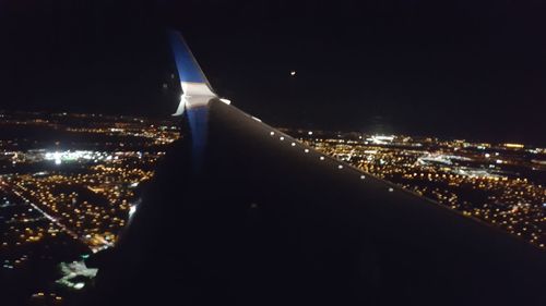 Aerial view of city lit up at night